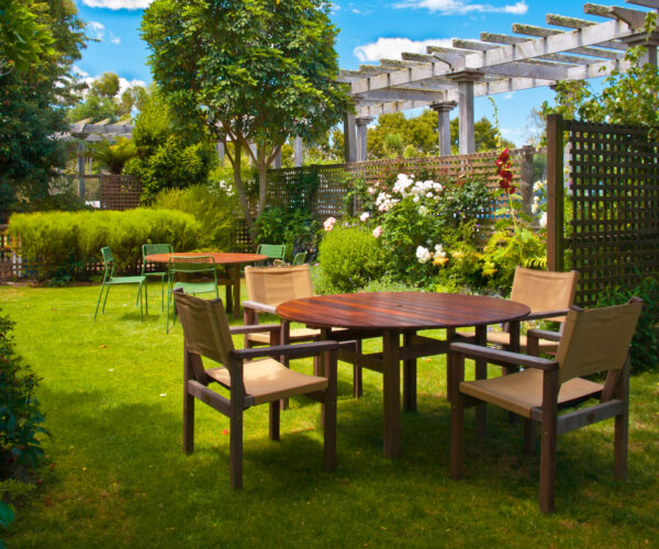 Landscaped Garden with Wooden Dining Table Set in the Shade of Trees