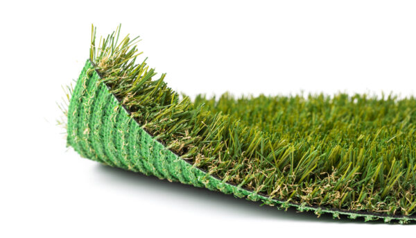 Flipped Up Section of Artificial Turf Grass On White Background. Flipped Up Section of Artificial Turf Grass On White Background.