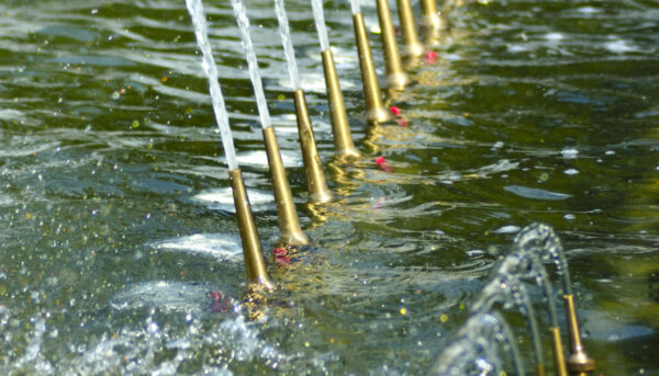 The gush of water of a fountain. Splash of water in the fountain, nozzle water.